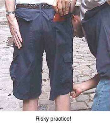 A man keeping his wallet in his back pocket. A man keeping his wallet in his back pocket.