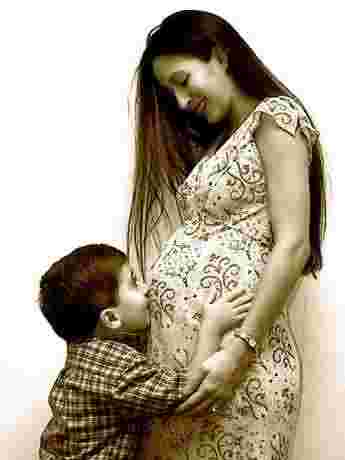 A pregnant woman with her son.